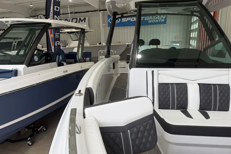 Slide: The Image of 2026 Monterey Elite 30 OB boat interior with luxurious seating in showroom. - 4