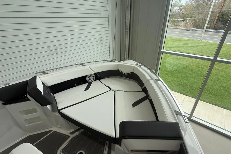 Slide: The Image of 2026 Monterey Elite 30 OB boat interior with sleek white seating and modern design. - 6