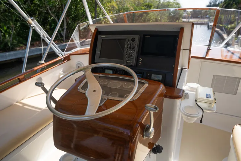 Slide: The Image of Helm of 1970 Rybovich 54 yacht with wooden steering wheel and navigation equipment. - 12