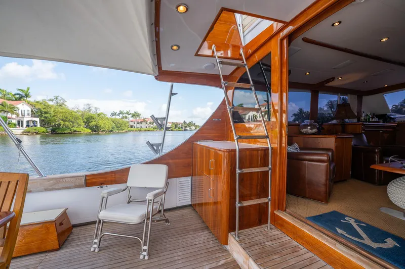 Slide: The Image of Luxurious 1970 Rybovich 54 yacht interior with wooden finishes and scenic water view. - 20