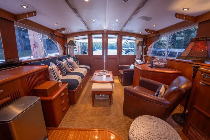 Slide: The Image of Luxurious interior of a 1970 Rybovich 54 yacht with elegant wood finishes and plush seating. - 22