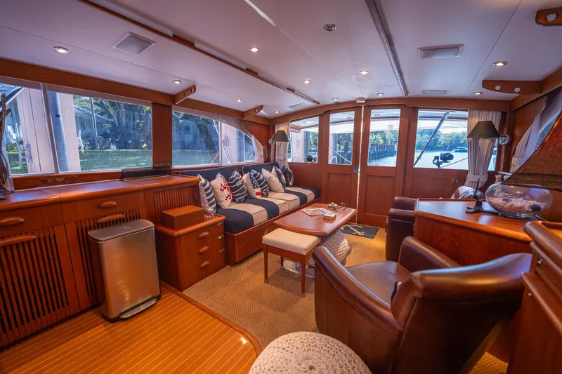 Slide: The Image of Luxurious interior of a 1970 Rybovich 54 yacht with elegant wood finishes and plush seating. - 23