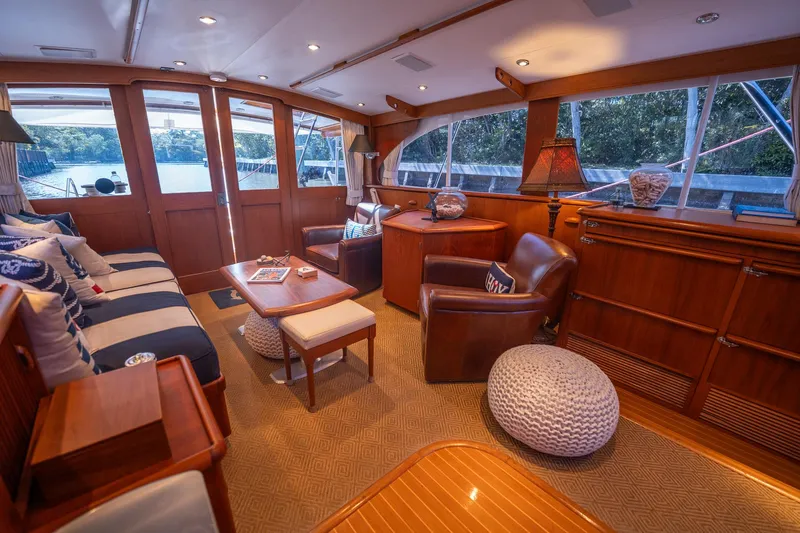 Slide: The Image of Luxurious interior of a 1970 Rybovich 54 yacht with elegant wood finishes and comfortable seating. - 24