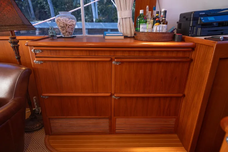 Slide: The Image of 1970 Rybovich 54 yacht interior with wooden cabinetry and bar setup. - 26