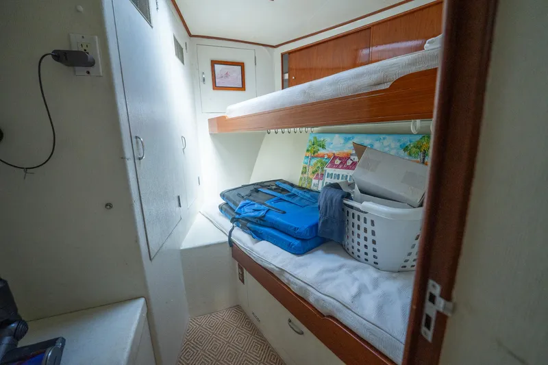 Slide: The Image of Interior of 1970 Rybovich 54 boat with bunk beds and storage items. - 29