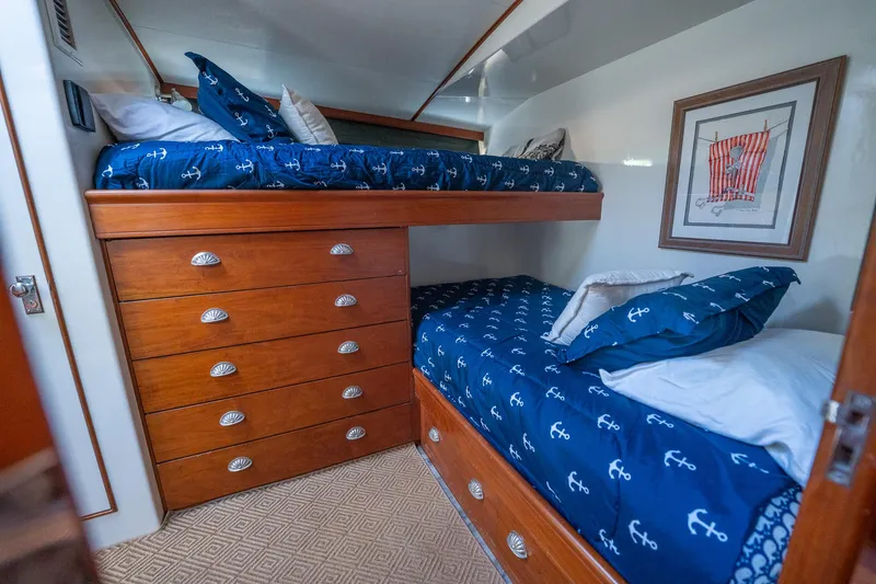 Slide: The Image of Interior of 1970 Rybovich 54 yacht with wooden bunk beds and nautical-themed bedding. - 31