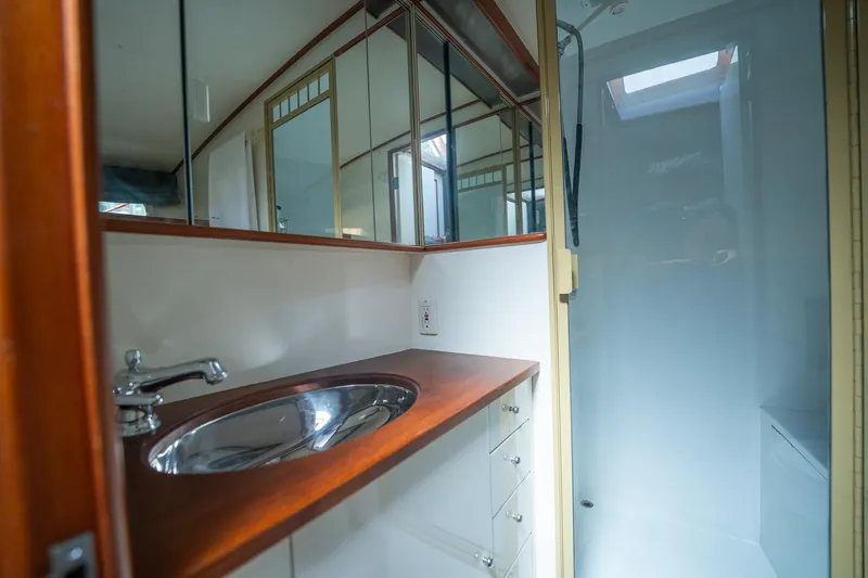 Slide: The Image of 1970 Rybovich 54 yacht bathroom with wooden countertop and stainless steel sink. - 34