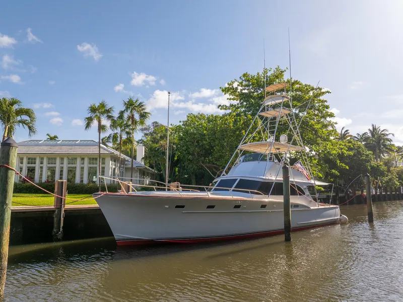 Slide: The Image of 1970 Rybovich 54 yacht docked by a tropical waterfront home. - 35