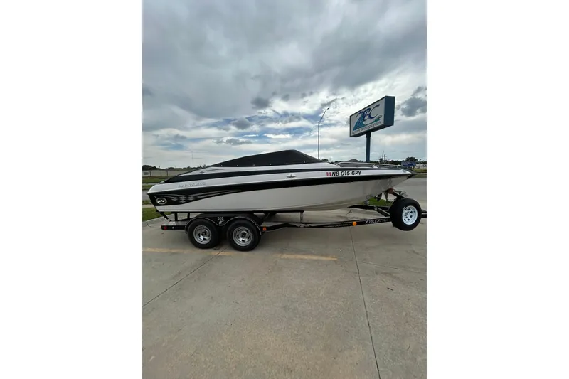Slide: The Image of 2004 Crownline 202 BR boat on trailer under cloudy sky. - 0