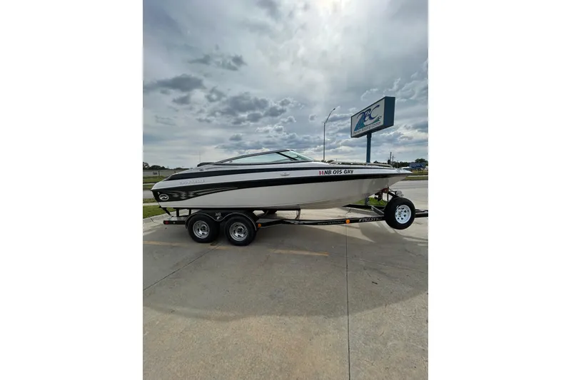 Slide: The Image of 2004 Crownline 202 BR boat on trailer under cloudy sky. - 1