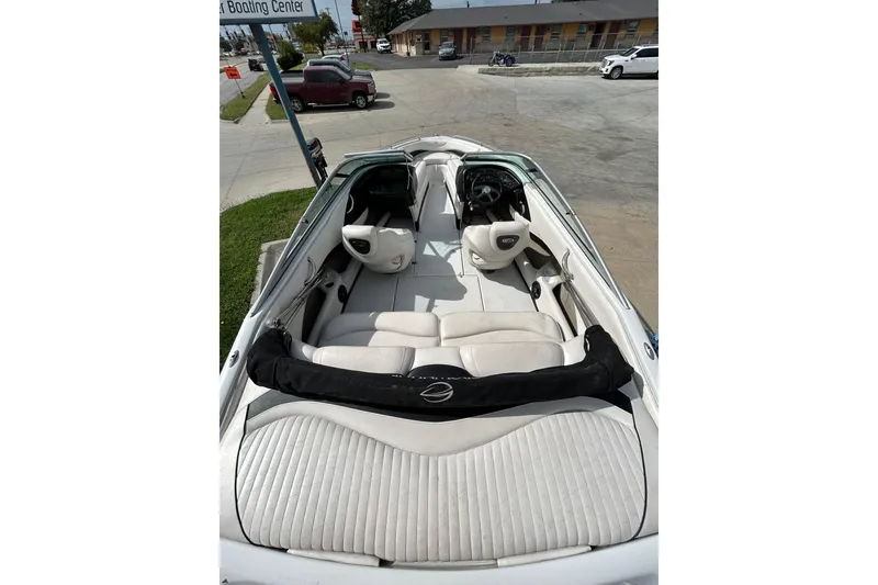 Slide: The Image of 2004 Crownline 202 BR boat interior with white seating and steering wheel. - 15