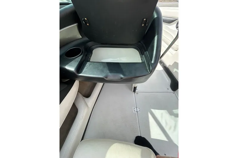 Slide: The Image of 2004 Crownline 202 BR boat interior with seating and cup holder. - 18