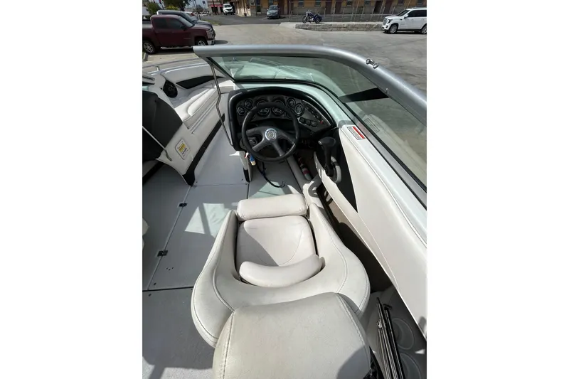 Slide: The Image of 2004 Crownline 202 BR boat interior with steering wheel and seating. - 20