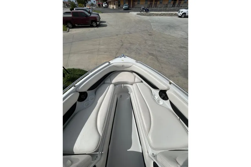 Slide: The Image of 2004 Crownline 202 BR boat interior with white seating and cup holders. - 21