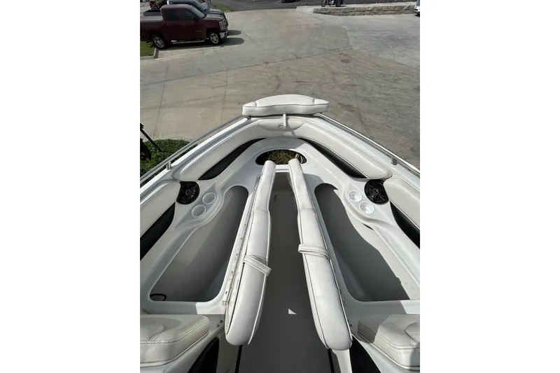 Slide: The Image of 2004 Crownline 202 BR boat interior with white seating and cup holders. - 22