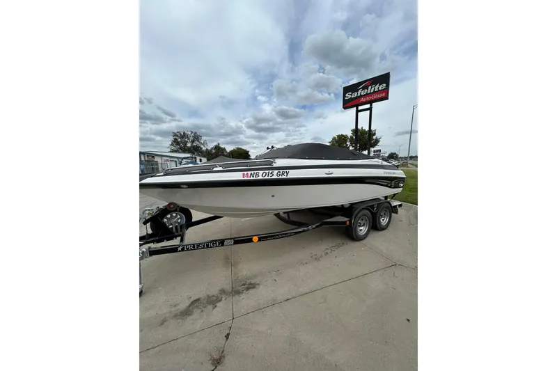 Slide: The Image of 2004 Crownline 202 BR boat on trailer, parked near Safelite AutoGlass sign. - 3