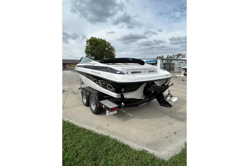 Slide: The Image of 2004 Crownline 202 BR boat on trailer, parked outdoors under cloudy sky. - 7