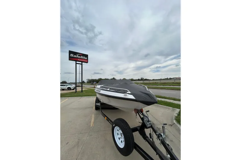 Slide: The Image of 2004 Crownline 202 BR boat on trailer, parked near Safelite AutoGlass sign. - 9