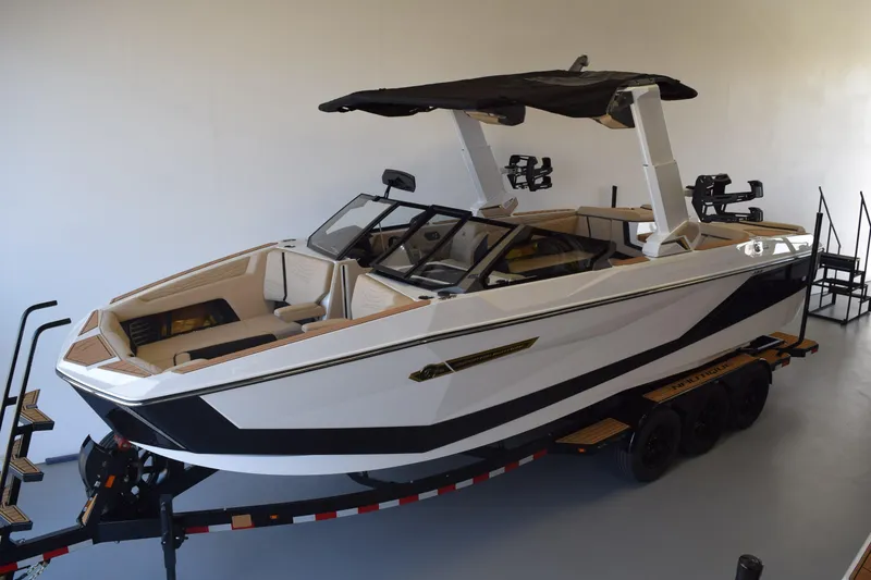 The Image of 2026 Nautique Super Air Nautique G25 Paragon boat on trailer in showroom. - 0