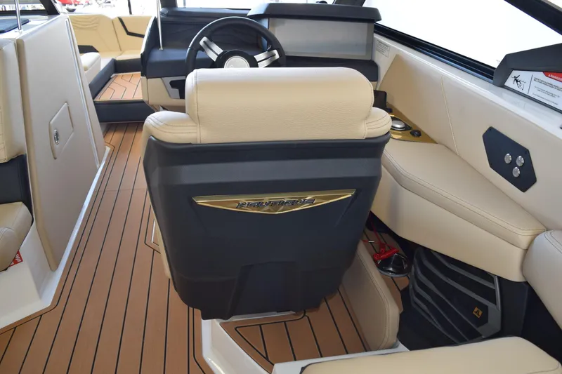 Slide: The Image of 2026 Nautique Super Air Nautique G25 Paragon interior with beige seating and sleek dashboard. - 11