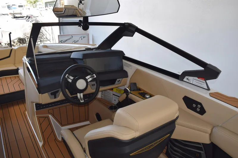 Slide: The Image of Interior of 2026 Nautique Super Air Nautique G25 Paragon boat, featuring modern helm design. - 12