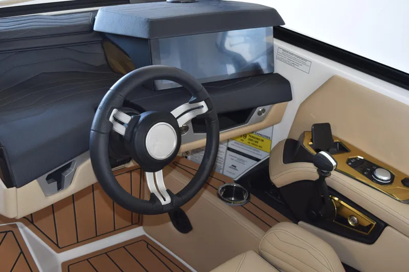 Slide: The Image of 2026 Nautique Super Air Nautique G25 Paragon cockpit with modern steering and controls. - 13