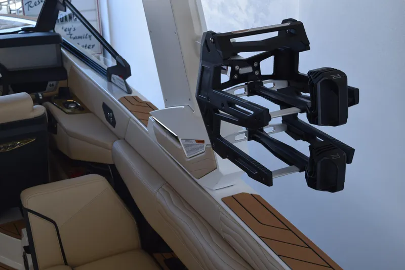 Slide: The Image of 2026 Nautique Super Air Nautique G25 Paragon interior with wakeboard rack and luxury seating. - 18