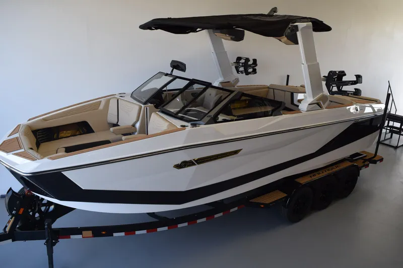 Slide: The Image of 2026 Nautique Super Air Nautique G25 Paragon boat on trailer, sleek design, luxury interior. - 26