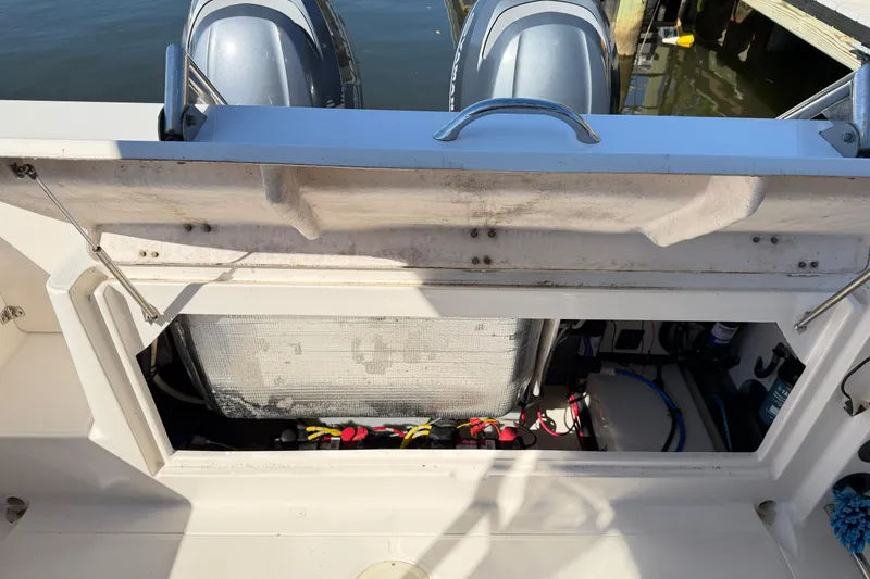Slide: The Image of 2014 Robalo R245 Walkaround boat engine compartment with dual outboard motors. - 10