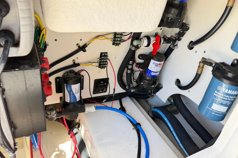 Slide: The Image of Electrical and plumbing components inside a 2014 Robalo R245 Walkaround boat. - 11