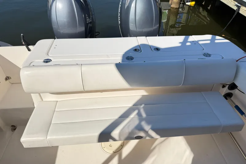 Slide: The Image of 2014 Robalo R245 Walkaround boat seating area with dual outboard motors. - 12