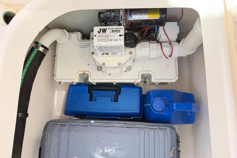 Slide: The Image of 2014 Robalo R245 Walkaround boat compartment with vacuum generator and storage containers. - 17
