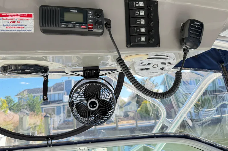 Slide: The Image of 2014 Robalo R245 Walkaround boat interior with radio, fan, and control panel. - 18