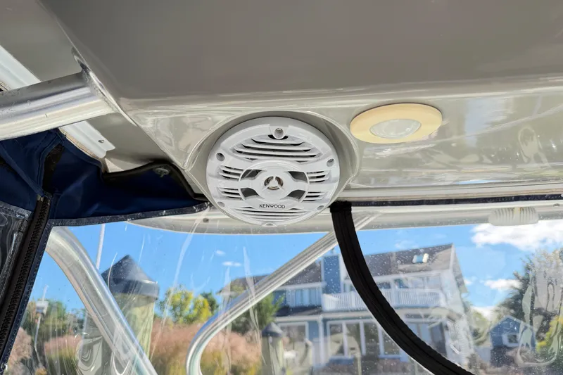Slide: The Image of Kenwood speaker and light on 2014 Robalo R245 Walkaround boat ceiling. - 19