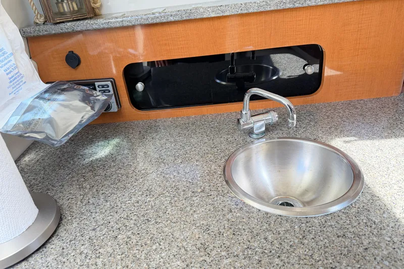 Slide: The Image of 2014 Robalo R245 Walkaround boat interior with sink and countertop. - 28