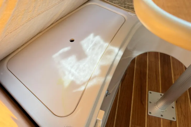 Slide: The Image of 2014 Robalo R245 Walkaround interior with wooden flooring and storage compartment. - 29