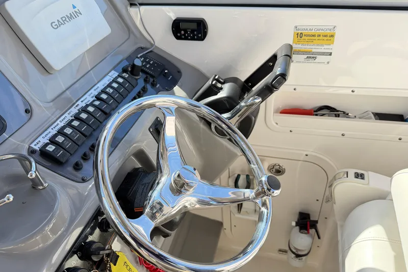 Slide: The Image of 2014 Robalo R245 Walkaround helm with Garmin navigation and steering wheel. - 37