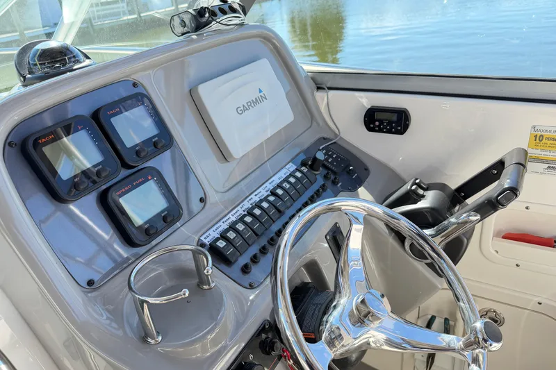 Slide: The Image of Control panel of 2014 Robalo R245 Walkaround boat with Garmin navigation system. - 38