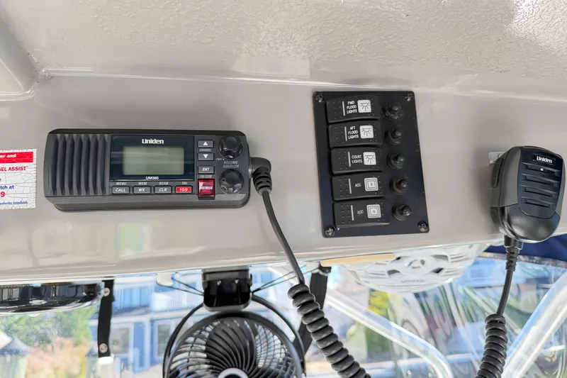 Slide: The Image of Control panel and radio on 2014 Robalo R245 Walkaround boat dashboard. - 39