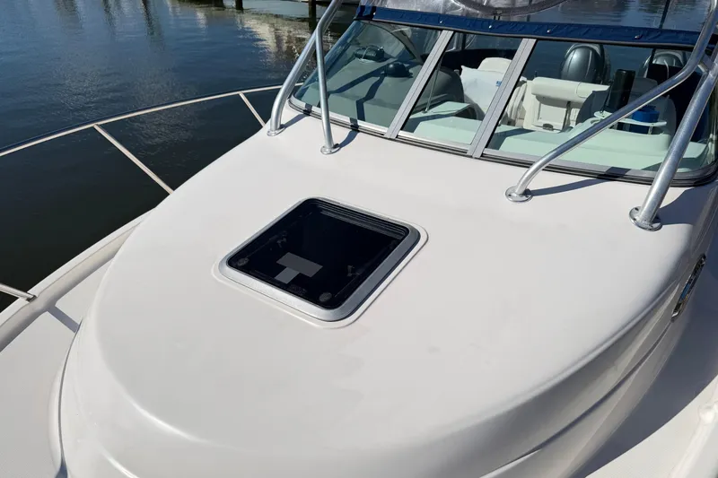Slide: The Image of 2014 Robalo R245 Walkaround boat deck with hatch, railing, and windshield. - 41