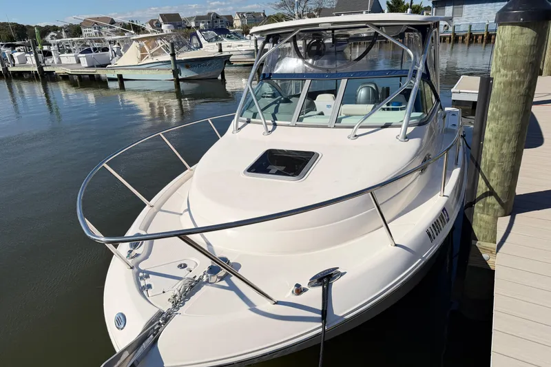 Slide: The Image of 2014 Robalo R245 Walkaround boat docked at a marina. - 42