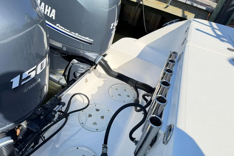 Slide: The Image of 2014 Robalo R245 Walkaround with Yamaha 150 engines and rod holders. - 43