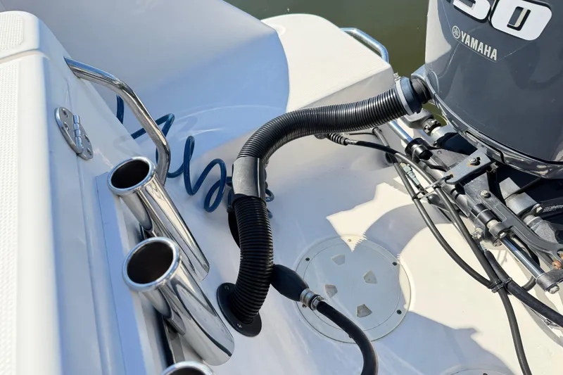 Slide: The Image of 2014 Robalo R245 Walkaround boat with Yamaha engine and rod holders. - 44