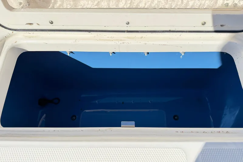 Slide: The Image of Open storage compartment on 2014 Robalo R245 Walkaround boat, showing interior space. - 5