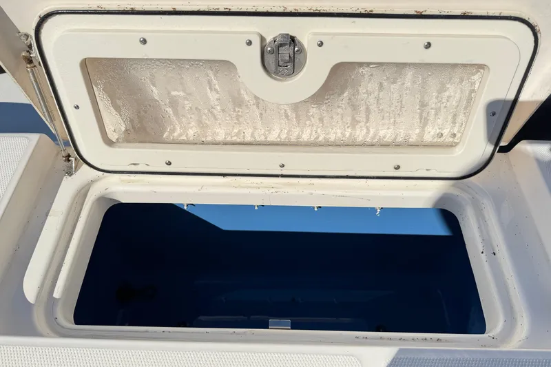 Slide: The Image of Open storage compartment on a 2014 Robalo R245 Walkaround boat. - 6