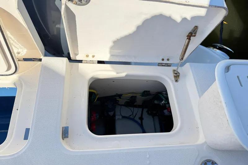 Slide: The Image of Open storage compartment on a 2014 Robalo R245 Walkaround boat. - 8