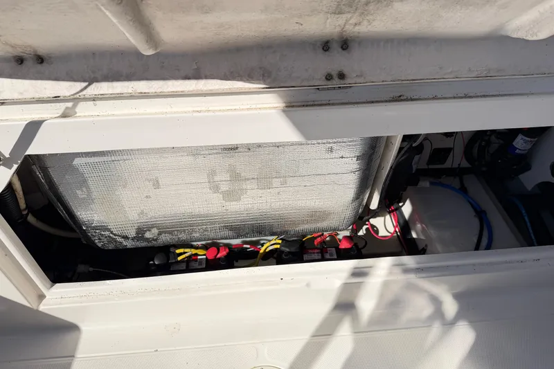Slide: The Image of 2014 Robalo R245 Walkaround boat battery compartment with wiring and insulation. - 9