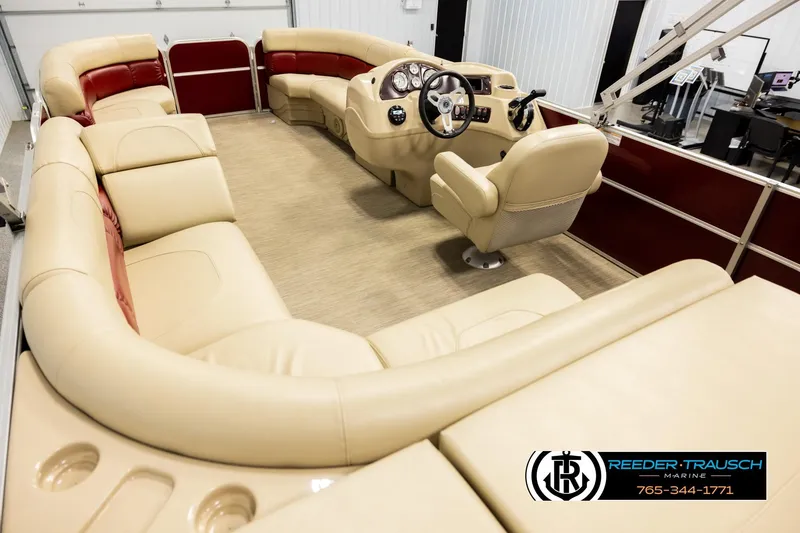 Slide: The Image of 2018 Misty Harbor 2085 CR pontoon boat interior with beige seating and steering console. - 11