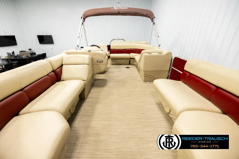 Slide: The Image of 2018 Misty Harbor 2085 CR pontoon boat with beige and red seating in showroom. - 13