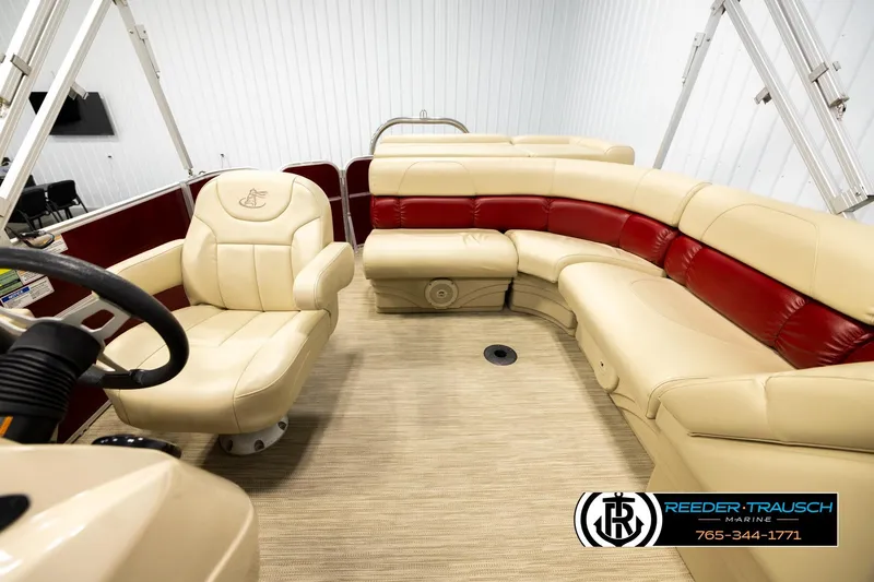 Slide: The Image of 2018 Misty Harbor 2085 CR boat interior with beige and red seating, steering wheel visible. - 14